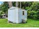 Outdoor storage shed in a grassy backyard with surrounding trees and vegetation at 2888 Middleton Cir, Kissimmee, FL 34743