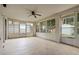 Enclosed sunroom with multiple windows, ceiling fan, and sliding door to backyard at 2888 Middleton Cir, Kissimmee, FL 34743