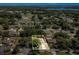 An aerial view of a home surrounded by lush trees in a serene neighborhood, providing a sense of privacy and natural beauty at 3014 Linmont Ln, Eustis, FL 32726