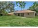 Spacious backyard with a covered patio, offering an ideal space for outdoor entertaining and enjoying the serene surroundings at 3014 Linmont Ln, Eustis, FL 32726