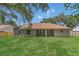 Expansive backyard with lush green grass and a spacious patio at 3014 Linmont Ln, Eustis, FL 32726