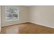 Bedroom with a large window, light walls, and wood-look floors at 3014 Linmont Ln, Eustis, FL 32726