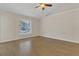 Large bedroom with hardwood floors, neutral walls, and a ceiling fan at 3014 Linmont Ln, Eustis, FL 32726