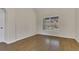Clean bedroom with wood floors, neutral walls, and a window view to the backyard at 3014 Linmont Ln, Eustis, FL 32726