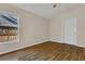 Cozy bedroom with a large window and stylish hardwood floors at 3014 Linmont Ln, Eustis, FL 32726