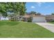 Charming single-story home with a well-manicured lawn and two-car garage at 3014 Linmont Ln, Eustis, FL 32726