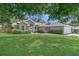 Well-maintained home featuring lush landscaping and a spacious front yard at 3014 Linmont Ln, Eustis, FL 32726
