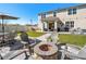 Inviting backyard patio with fire pit, outdoor seating, and well-maintained landscaping offers a relaxing retreat at 3077 Nottel Dr, St Cloud, FL 34772