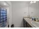 Bathroom featuring double sinks with dark cabinets and a shower/tub combo with a curtain at 3077 Nottel Dr, St Cloud, FL 34772