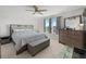 Bedroom featuring neutral colors, a ceiling fan, and multiple windows that provide natural light at 3077 Nottel Dr, St Cloud, FL 34772