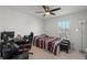 Bright bedroom with a ceiling fan, desk, and a window that offers natural light at 3077 Nottel Dr, St Cloud, FL 34772