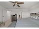 Bedroom with a ceiling fan, dresser, bed and a bench, and views to the hallway at 3077 Nottel Dr, St Cloud, FL 34772