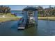 A close up view of the covered boat lift and dock at 3077 Nottel Dr, St Cloud, FL 34772