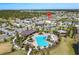 Aerial view of community pool and clubhouse with mature trees, parking, and seating areas at 3077 Nottel Dr, St Cloud, FL 34772