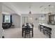 Open dining area with modern lighting fixtures, breakfast bar and views of the outdoor living area at 3077 Nottel Dr, St Cloud, FL 34772