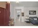 Welcoming foyer with neutral tile flooring, coat closet, furniture piece, leading to a dining and living area at 3077 Nottel Dr, St Cloud, FL 34772