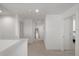 Neutral hallway with carpet, white walls, and multiple doors, leading to various rooms at 3077 Nottel Dr, St Cloud, FL 34772