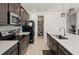 Well-equipped kitchen with stainless steel appliances, a center island with counter seating and a tile backsplash at 3077 Nottel Dr, St Cloud, FL 34772