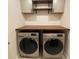 Laundry room featuring a modern washer and dryer, and floating shelves at 3077 Nottel Dr, St Cloud, FL 34772