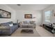 Neutral living room with comfortable seating, modern decor, neutral tile flooring, and natural light at 3077 Nottel Dr, St Cloud, FL 34772