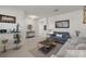 Comfortable living room featuring neutral tile flooring, modern decor, neutral color palette, and natural light at 3077 Nottel Dr, St Cloud, FL 34772