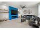 Stylish living room showcasing a striking blue accent wall, built-in shelving, and a comfortable sectional sofa at 3077 Nottel Dr, St Cloud, FL 34772