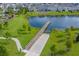 Aerial view of community pond featuring a long pier and easy access for residents at 3077 Nottel Dr, St Cloud, FL 34772