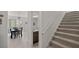 Carpeted staircase with a white handrail, leading to the upper level, and view of dining area at 3077 Nottel Dr, St Cloud, FL 34772