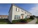 Two-story townhome with manicured shrubs and landscaping at 3128 Camino Real N Dr, Kissimmee, FL 34744