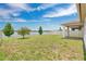 Backyard with lake view, lush grass, privacy fence and paver patio at 3953 Baja Dr, St Cloud, FL 34772