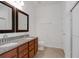 Bathroom featuring a double vanity with granite countertop, tile flooring and a walk-in shower at 3953 Baja Dr, St Cloud, FL 34772