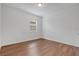 This bright bedroom features a window and wood-look flooring at 3953 Baja Dr, St Cloud, FL 34772