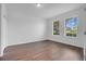 Bright and airy bedroom featuring two windows, wood flooring and neutral walls at 3953 Baja Dr, St Cloud, FL 34772