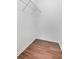 Walk-in closet provides ample storage with a single wire shelf and wood-look flooring at 3953 Baja Dr, St Cloud, FL 34772