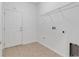 Tiled laundry room features a utility sink hookups, shelving and access to outside at 3953 Baja Dr, St Cloud, FL 34772