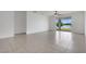 Spacious living room with neutral tile flooring, a ceiling fan and sliding glass doors leading to a patio at 3953 Baja Dr, St Cloud, FL 34772