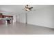Open concept living room with neutral tile flooring and a ceiling fan at 3953 Baja Dr, St Cloud, FL 34772