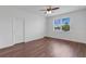 This bright main bedroom offers a ceiling fan, wood-look flooring, and ample natural light at 3953 Baja Dr, St Cloud, FL 34772
