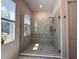 Bathroom with large glass shower featuring white marble and a built in bench at 5161 Kingwell Cir, Oviedo, FL 32765