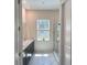 Bright bathroom with double sinks, modern fixtures, and a glass-enclosed shower at 5161 Kingwell Cir, Oviedo, FL 32765