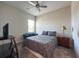 Bedroom with a queen bed, TV, and a blue chair at 5161 Kingwell Cir, Oviedo, FL 32765