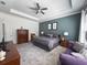 Well-lit bedroom with soft gray carpet, a ceiling fan, and stylish furniture arrangement at 5161 Kingwell Cir, Oviedo, FL 32765