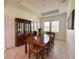 Inviting dining room with windows, display cabinet, and tile floors at 5161 Kingwell Cir, Oviedo, FL 32765