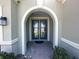 Elegant entryway with arched door frame and double doors at 5161 Kingwell Cir, Oviedo, FL 32765