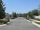 Gated community entrance with decorative stone pillars and mature landscaping at 5161 Kingwell Cir, Oviedo, FL 32765