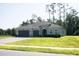 Charming single-story home with lush lawn, three car garage, and mature trees at 5161 Kingwell Cir, Oviedo, FL 32765