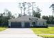Beautiful home featuring a three car garage and a well-manicured lawn at 5161 Kingwell Cir, Oviedo, FL 32765