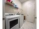 The laundry room includes a washer, dryer, and wire shelving for extra storage at 5161 Kingwell Cir, Oviedo, FL 32765