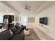 Bright living room featuring a ceiling fan, recessed lighting, and tiled floor, with an adjacent modern kitchen at 5161 Kingwell Cir, Oviedo, FL 32765
