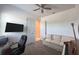 A living room with a couch, piano, ceiling fan, desk and tv at 5161 Kingwell Cir, Oviedo, FL 32765